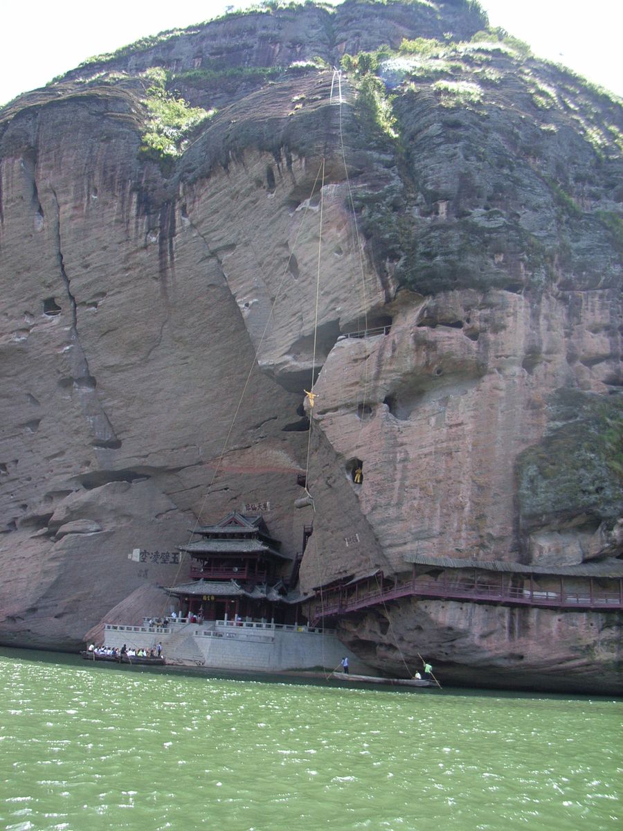 Ancient wooden cliff coffins (hanging coffins) of the Yue people wedged high in the rock face above the Luxi River at Longhushan